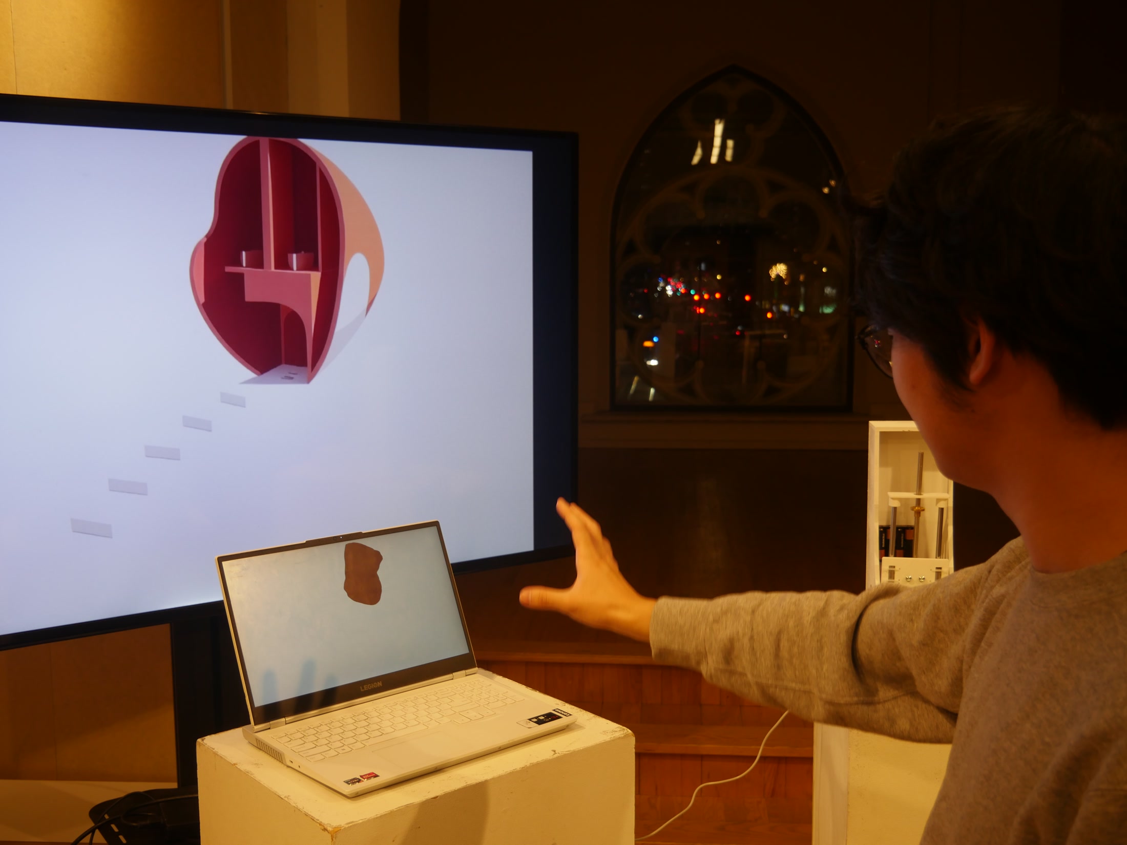 Participant gesturing toward an AI-generated architectural form
