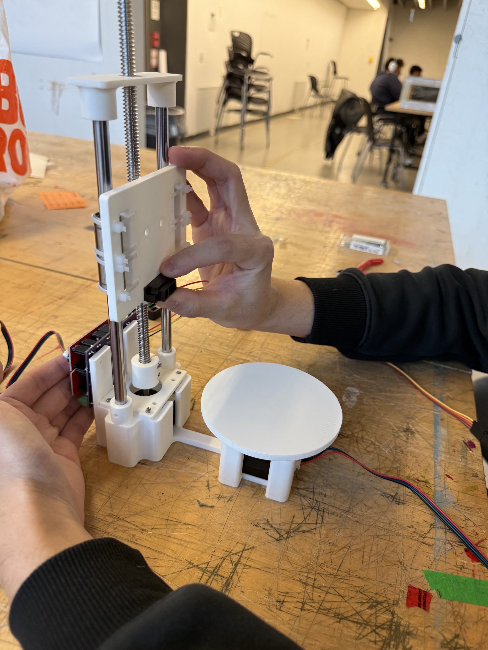 Hands assembling the custom scanner structure