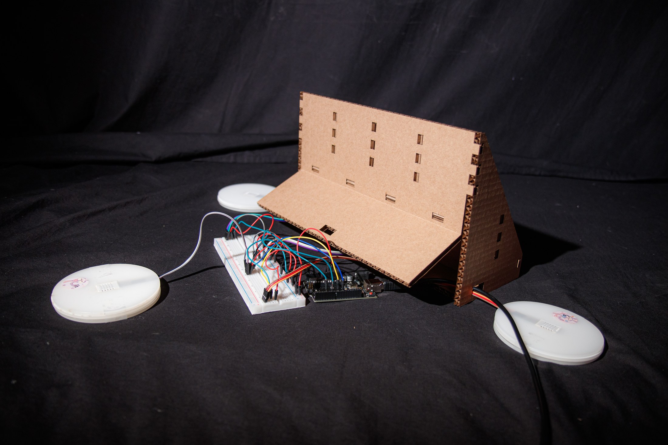 Rear view of the assembled tea display, sensor coasters, Arduino, and breadboard